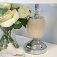 Contemporary bedside lamp with crystal accent creating warm ambient lighting
