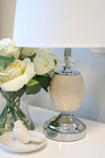 Contemporary bedside lamp with crystal accent creating warm ambient lighting
