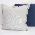 Coral Bay Embroidered Cushion in Natural featuring white coral embroidery and soft flange edging styled with a navy cushion for relaxed coastal living room décor