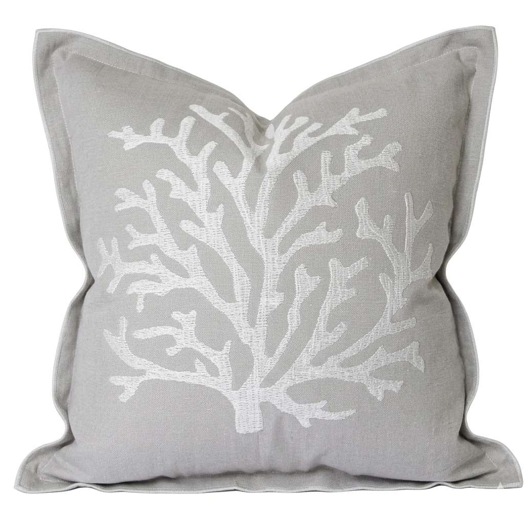 Natural cotton cushion with white embroidered coral design in a coastal Hamptons style