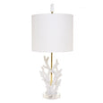 Luxury coral table lamp with gold stem, acrylic base and white linen drum shade styled in a coastal-luxe interior
