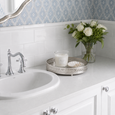 Cove Shell Trinket Dish in white ceramic with gold trim styled with jewellery on an elegant Hamptons bathroom vanity.