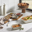 Darley Stoneware Bakeware dishes styled in a relaxed kitchen setting with serving boards and baked meals