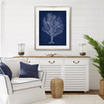 Curious Coral Delight VIII Designer Boys navy coral artwork styled above a white sideboard in a classic blue and white Hamptons coastal living room.