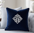 navy monogram cushion layered on sofa with striped cushions, Hamptons style living room