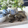 Dove Lovebirds Set of 2 Sculptures Antique featuring two detailed bird ornaments in an aged brass and copper metallic finish in a rattan tray with other blue and white decor