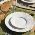 Dragonfly Stoneware White Side Plate layered with coordinating dinnerware on a green placemat, styled for outdoor coastal entertaining and relaxed dining.