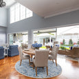 Eastport upholstered dining chairs in an open-plan Hamptons living and dining room