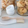Marble and timber spoon rest styled on a white kitchen countertop with warm natural textures.