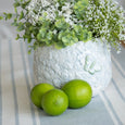 Blue and white Eliza Ceramic Pot styled with faux greenery and white flowers in a Hamptons dining setting