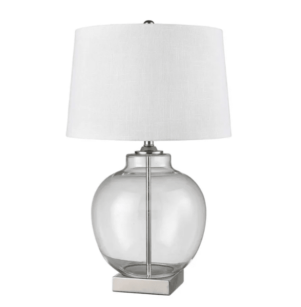 Ellyn glass and brass table lamp with round glass base and white linen shade on a bedside table