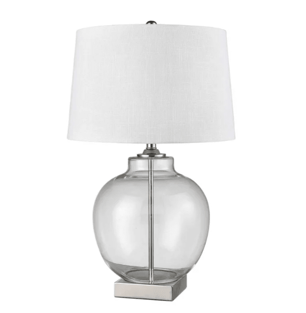 Ellyn glass and brass table lamp with round glass base and white linen shade on a bedside table