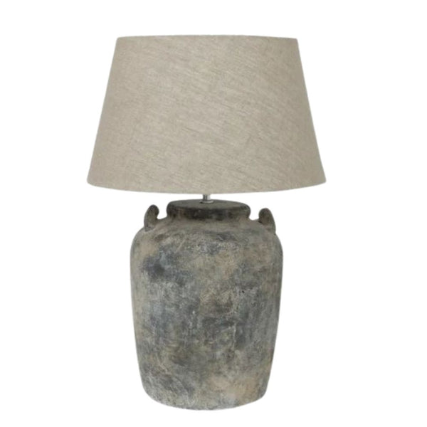 Emilia terracotta lamp base with aged grey finish and natural linen shade styled in a neutral interior
