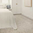 Emma Blomfield Veil Blue Rug styled beneath a bed in a calm white and neutral bedroom