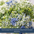 Eucalypt and Baby’s Breath Faux Floral Bunch combined with blue florals in a stone-look vase for coastal home styling.