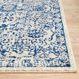 Edge detail of Eve Blue Rug showing woven border and textured blue botanical design