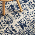 Detailed botanical pattern of Eve Blue Rug in layered azure blue and ivory tones