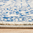 Close-up side profile of Eve Blue Rug showing plush low-pile construction