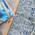 Eve Blue Runner with distressed blue pattern styled beside a grey upholstered bench