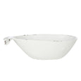 Side view of white cast iron whale dish with distressed coastal finish and sculptural whale tail detail.