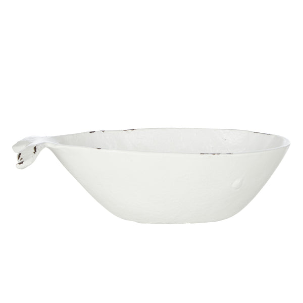 Side view of white cast iron whale dish with distressed coastal finish and sculptural whale tail detail.