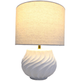 : Sculptural white ceramic Flynn lamp with textured linen shade in a neutral coastal living room
