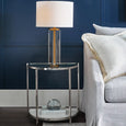 Angled view of the Forrester luxury crystal table lamp with brass rod detail and white linen shade.
