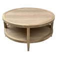 Front view of weathered oak round coffee table highlighting natural timber grain and open lower shelf storage.