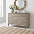 Georgia 8 Drawer Dresser styled with round mirror, white hydrangeas and coastal bedroom decor