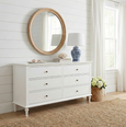 Georgia White 6 Drawer Dresser styled with a round rattan mirror, blue and white lamp and coastal décor in a Hamptons bedroom.