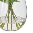 Clear glass vase with faux water and stems of artificial lisianthus