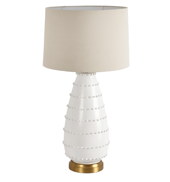Grace white ceramic table lamp with linen shade styled in a coastal living room