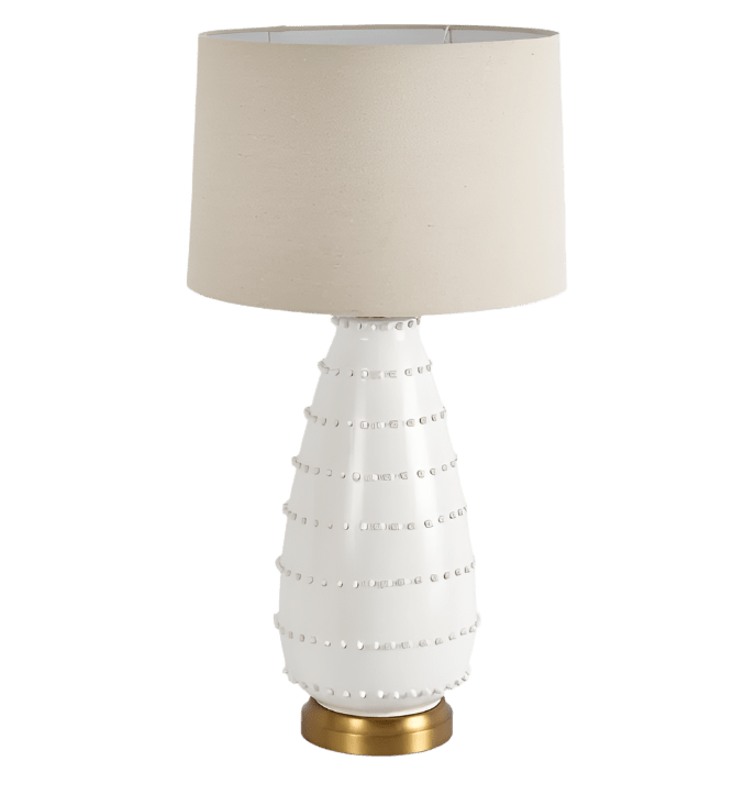Grace white ceramic table lamp with linen shade styled in a coastal living room