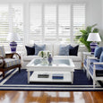 White Hampton Square Coffee Table styled in a relaxed coastal living room with blue cushions and natural textures