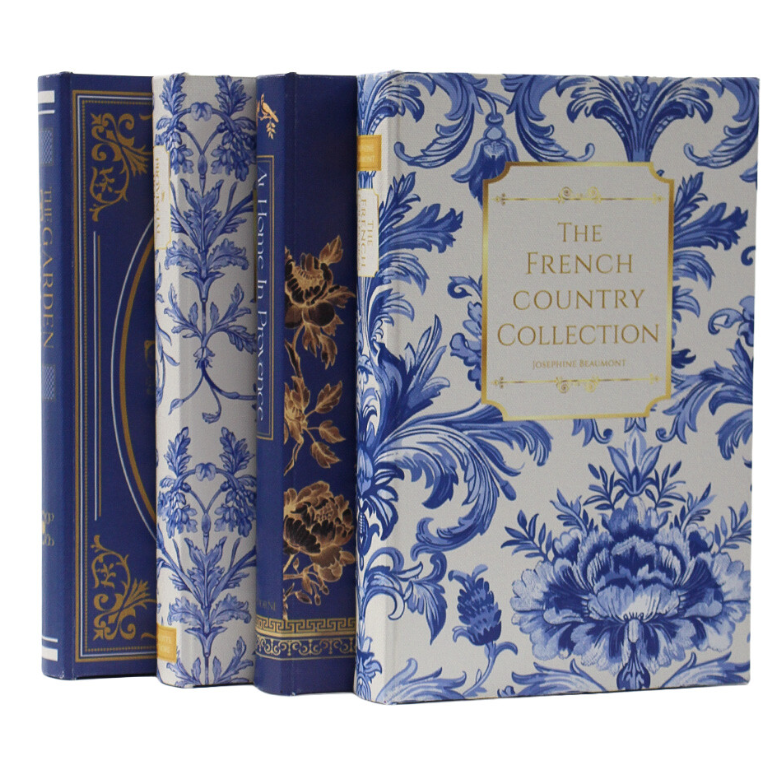 Set of four Hamptons decorative book boxes featuring navy, blue and white floral covers with elegant gold detailing.