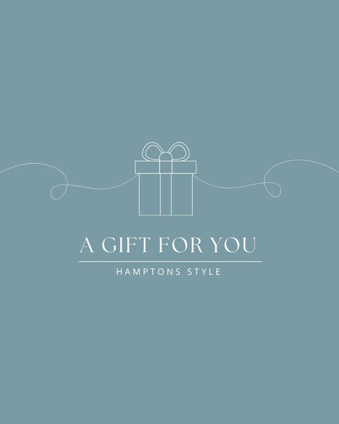 Hamptons Style gift card design with a simple white line illustration of a wrapped present on a blue background.