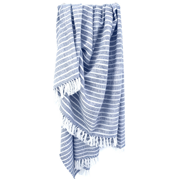 Harbour chambray blue striped throw blanket with soft woven texture and white fringe detailing draped for relaxed coastal bedroom or living room styling