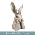 Small champagne-finished hare sculpture resting its chin on its paws with upright ears with top 10 best seller - february overlay