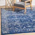 Harley Navy Rug styled in a contemporary living room with timber furniture and coastal-inspired décor.