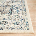 Close-up border detail of the Harley White Rug showing layered blue and charcoal vintage-inspired patterning