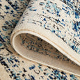Folded detail of the Harley White Rug displaying the flexible backing and textured woven finish