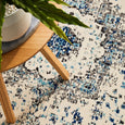 Harley White Rug styled beneath a timber side table showing rich blue accents and distressed detailing
