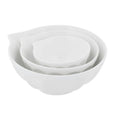 Set of three white porcelain mixing bowls with ridged detailing and pouring lip in coordinating nesting sizes.