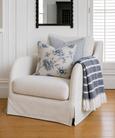 Hastings Armchair styled with blue floral cushions and striped coastal throw