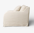 Side profile of the Hastings Armchair featuring curved arms and relaxed slipcover design