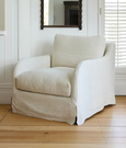 Hastings Armchair in natural linen blend fabric styled in a relaxed coastal interior