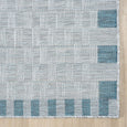 Haven Blue Outdoor Rug corner showing blue border detailing and neatly bound edge