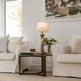 Hudson Table Lamp Base Brass with linen drum lamp shade styled on a side table between linen armchairs in a relaxed Hamptons living room.