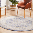 Hunter Ocean Round Rug creating a soft coastal focal point beneath an accent chair in a Hamptons-inspired interior.