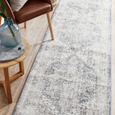 Hunter Ocean runner rug styled beside a leather accent chair and timber side table in a coastal-inspired hallway.